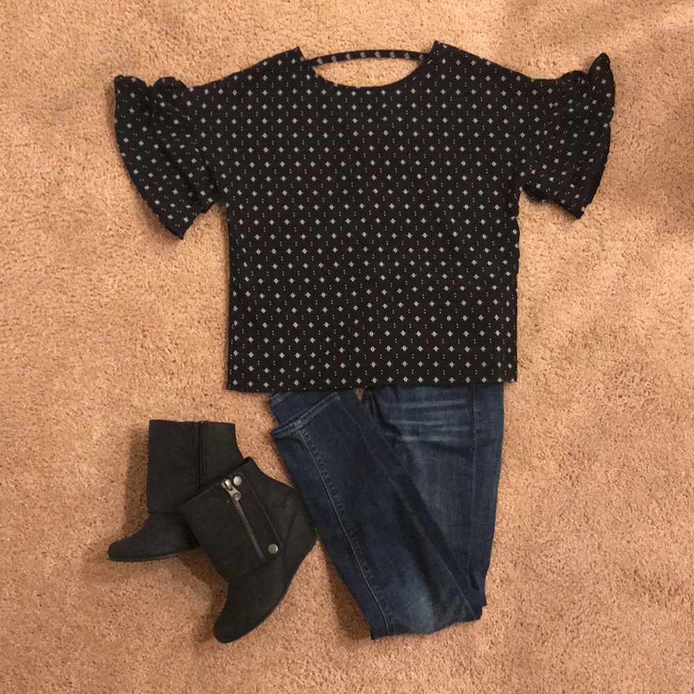 Ruffle sleeve top with a little back showing.